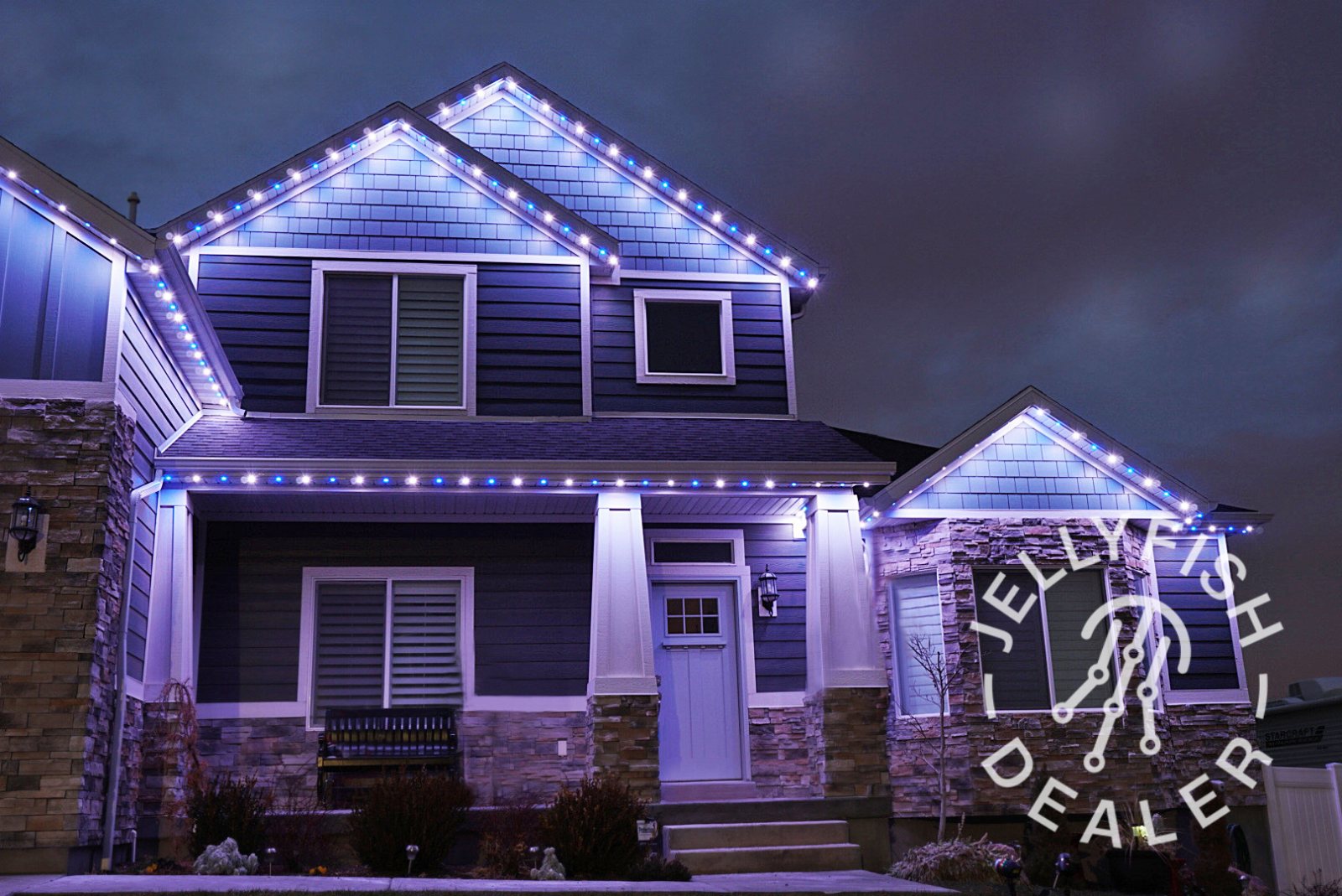 A lit front porch and walkway at night
