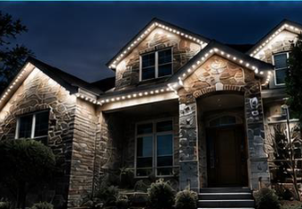 The front of a finished home with permanent lighting in warm white